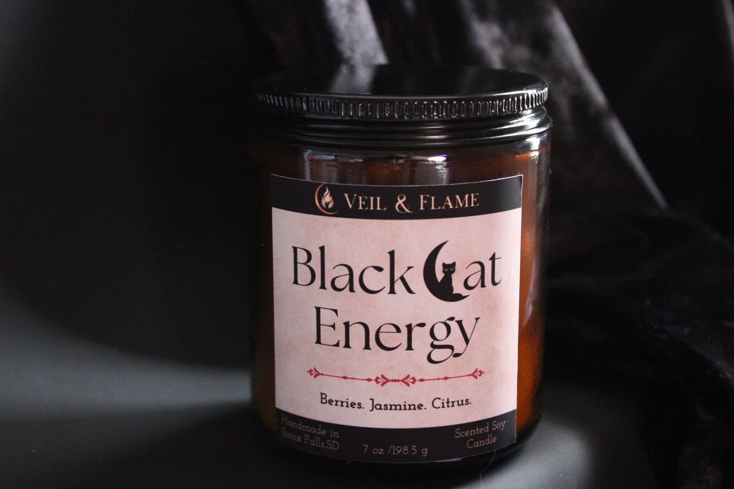 Jar of 'Black Cat Energy' candle by Veil & Flame on a dark background