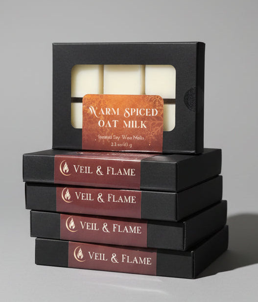 Veil & Flame wax melts in black box with window displayed on a wooden surface with a blurred store background
