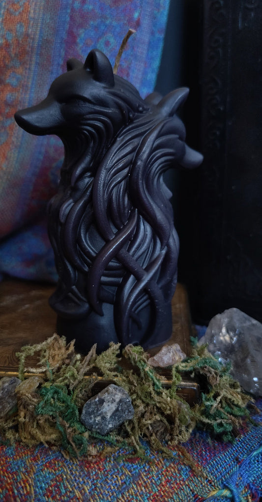 Decorative wolf head sculpture on a colorful fabric background