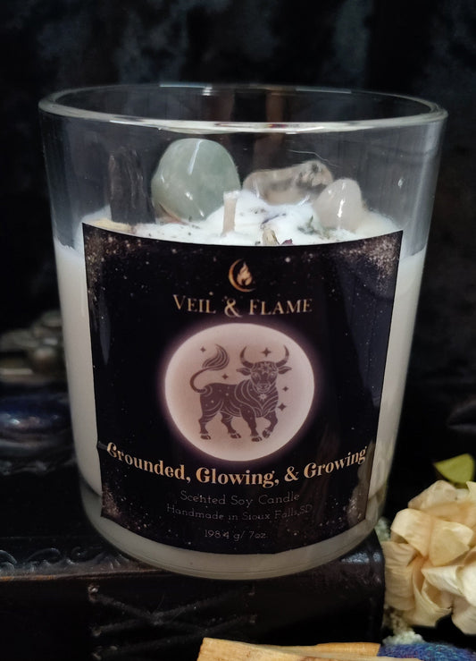 Candle with 'Veil & Flame' label and decorative elements on a dark background
